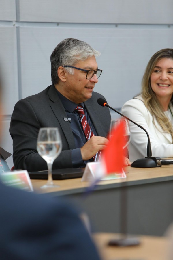 Ricardo Neves, ao microfone, ao lado de Blenda Couto, sorrindo